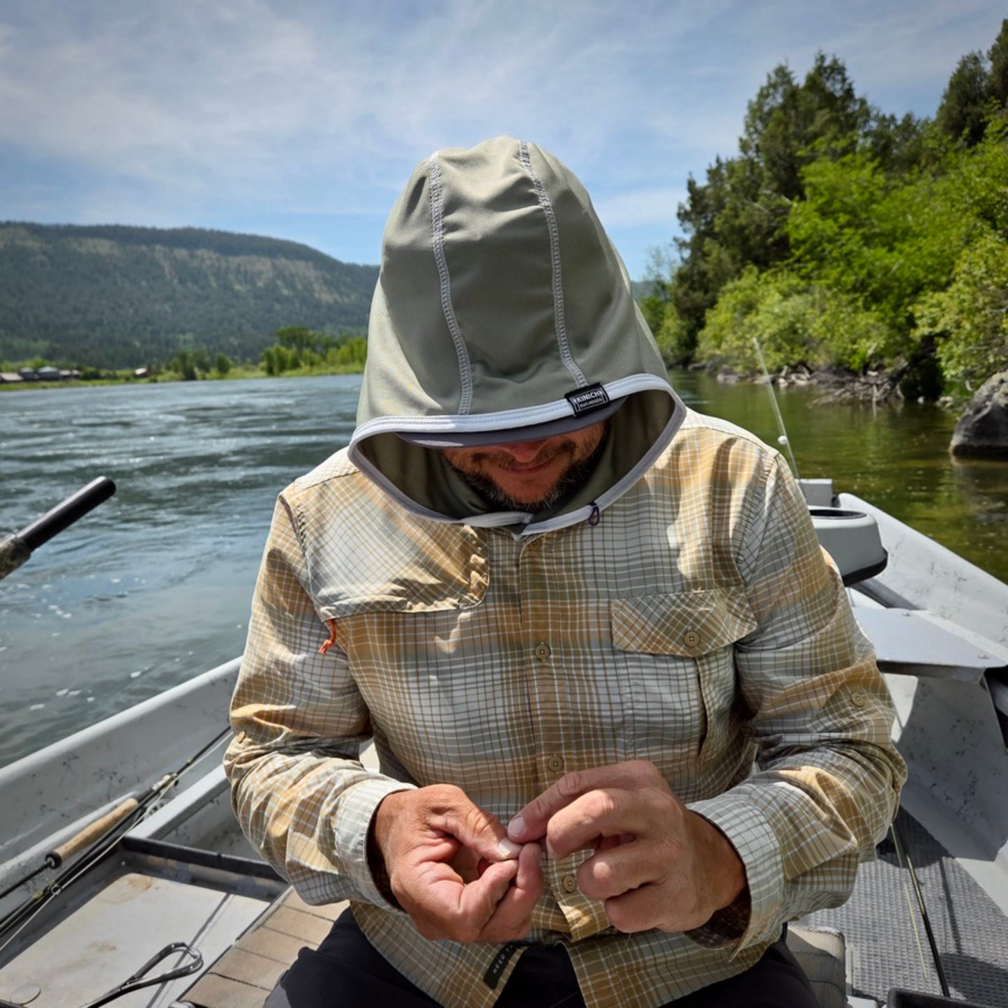 Fishing guide wearing Kinich Sun Hood in a boat.