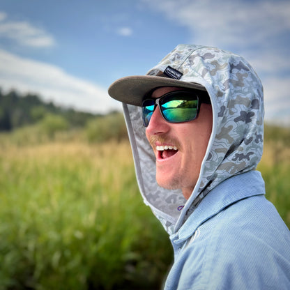 smiling young man wearing camo hood