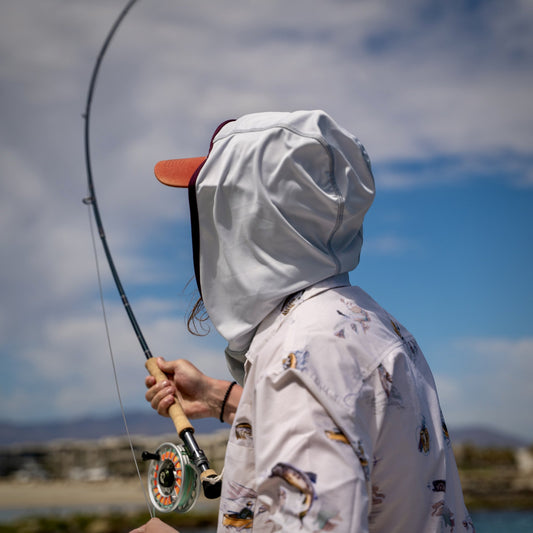 Fly fisherman wearing a kinich sun hood