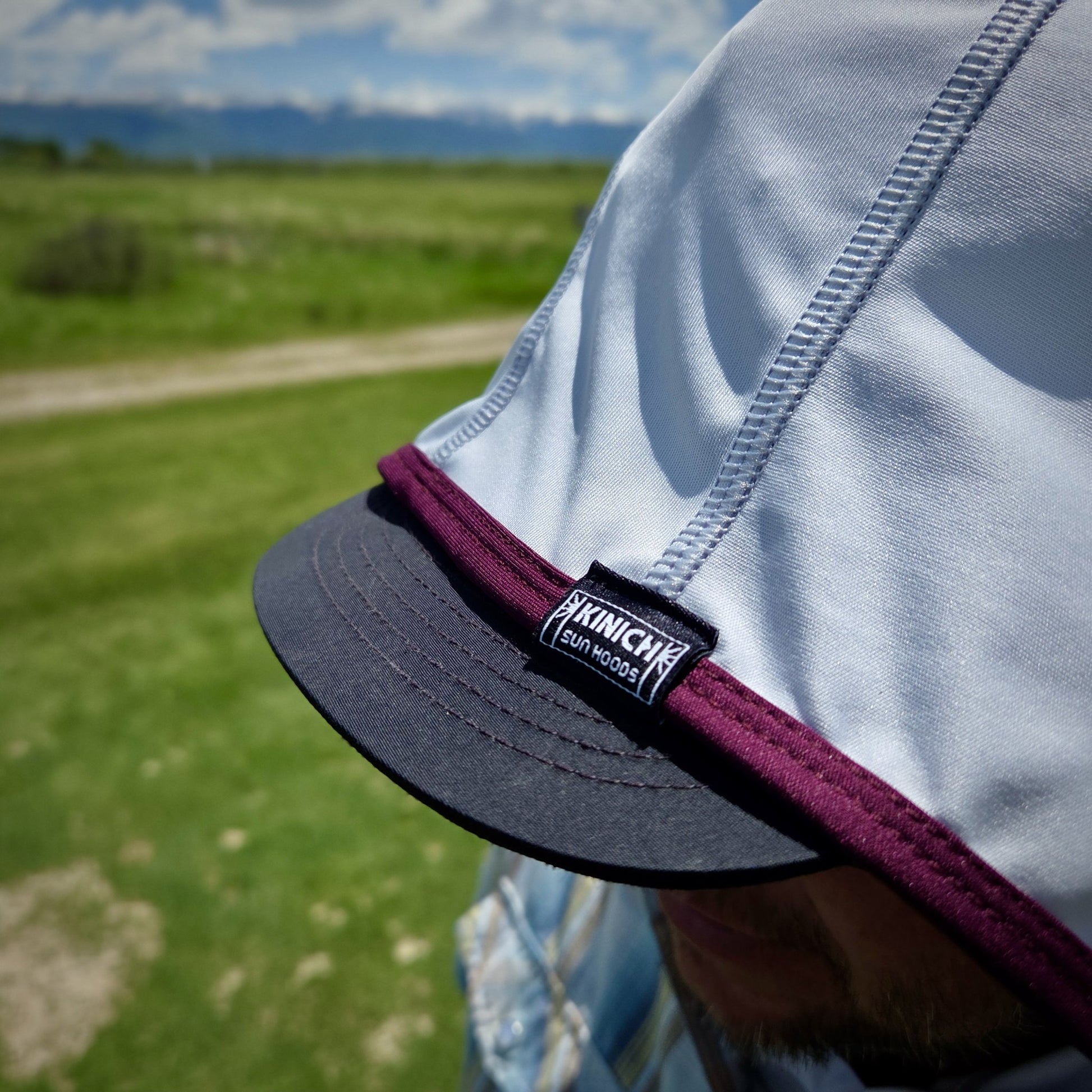 Close up of Kinich Sun Hood, light grey and wine